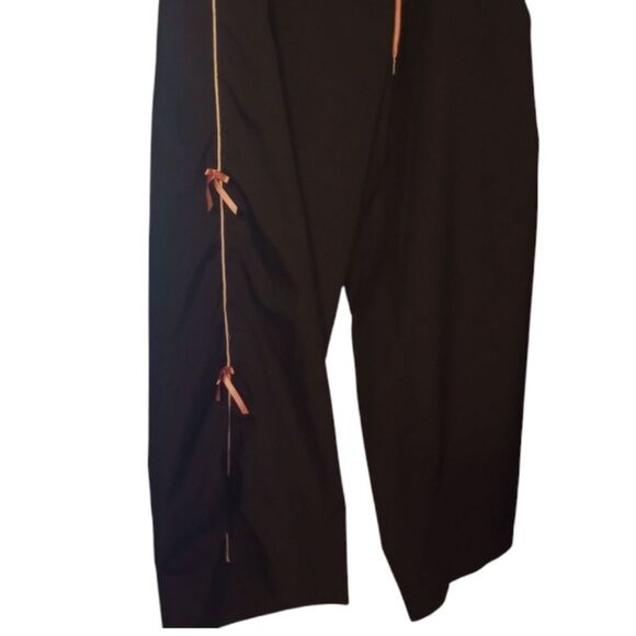 Elastic waist track style pants with pink bows accents on the sides - Picture 7 of 7